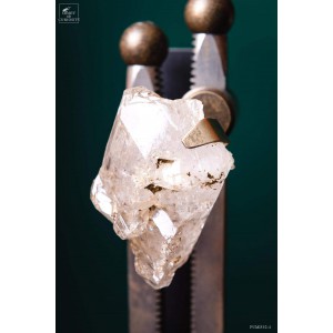 Crystal with prehistoric water on brass machinery 2