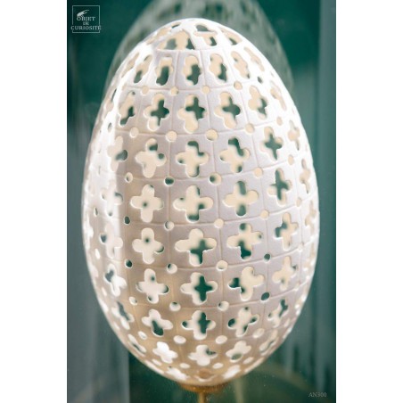 Sculptured egg of goose under glass, brass base