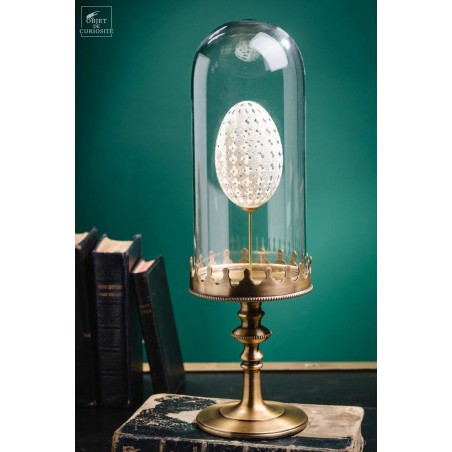 Sculptured egg of goose under glass, brass base