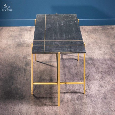 coffee table in black marble with brass lines inlay.