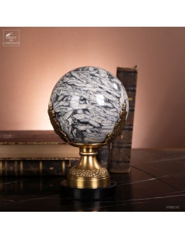 Ball of Pinolite on marble and brass...