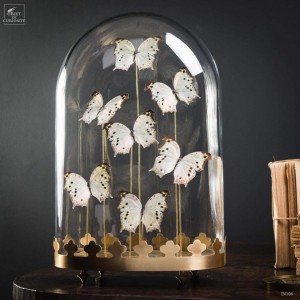 7 black  and white butterflies under oval glass